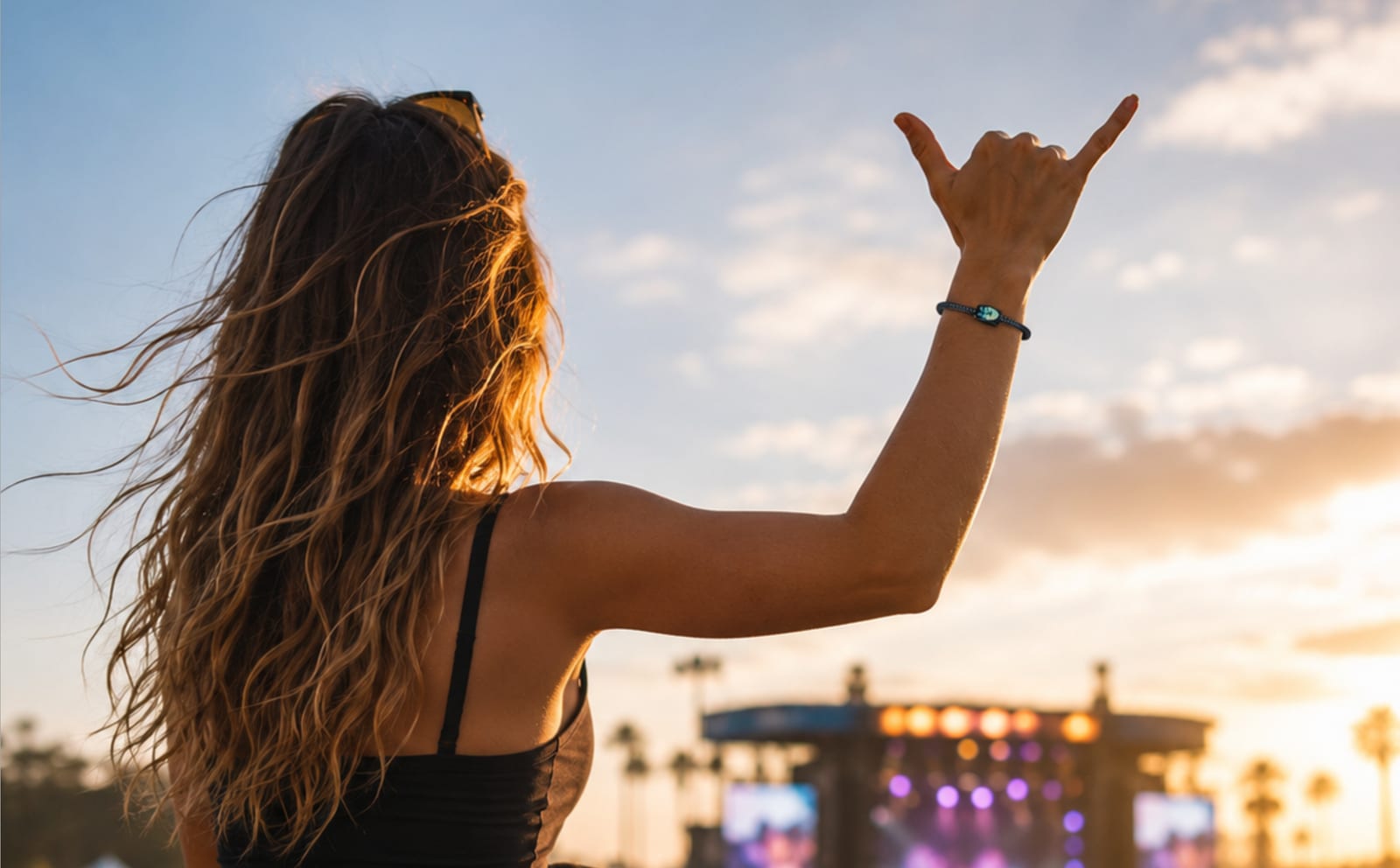 Festival-goer wearing a Totemband at sunset